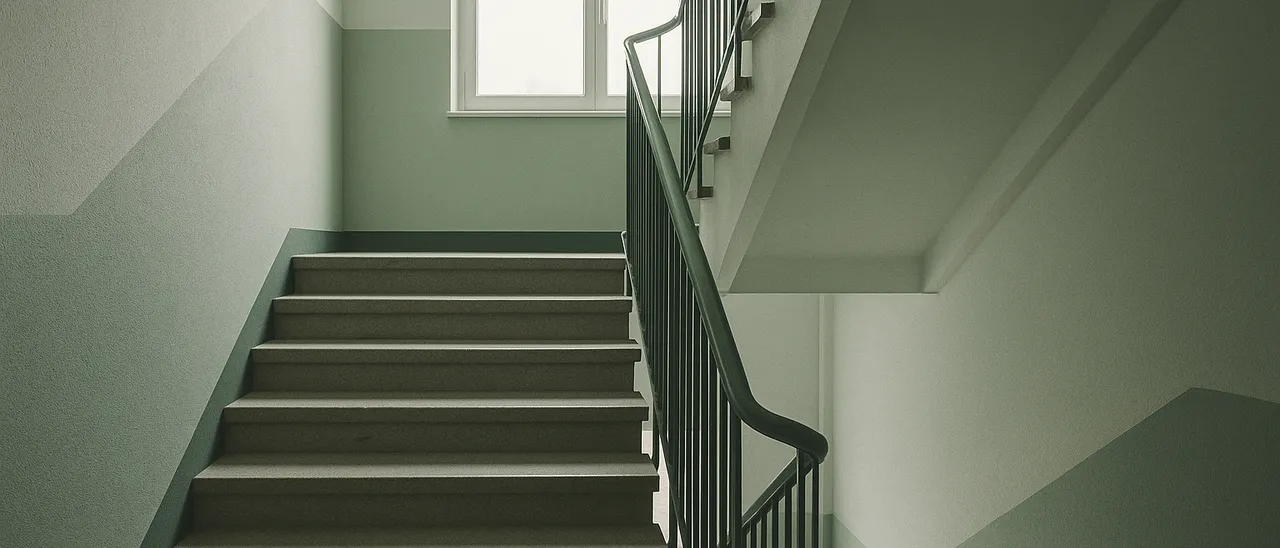 Gepflegtes Treppenhaus einer Wohnanlage mit Tageslicht und Steinstufen